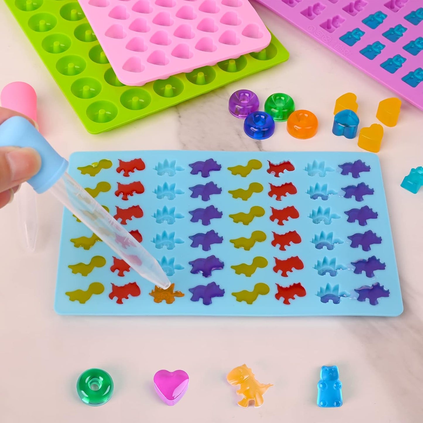 Sakolla Gummy Candy Molds Silicone with 2 Droppers Pack of 4 Mini Silicone Molds Including Dinosaur, Bear Shape, Hearts and Donut Gummie Chocolate Molds for Kids